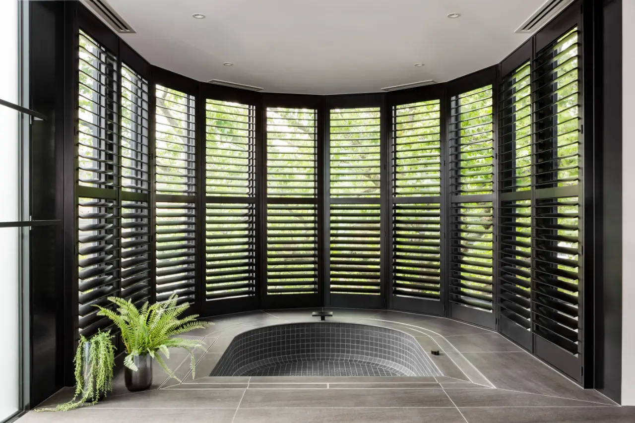 picture showing Made-to-Measure Plantation Shutters in black wrapped around a semi circle window