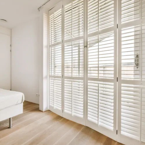 white bedroom with Made-to-Measure Plantation Shutters just like what Best Blinds can offer